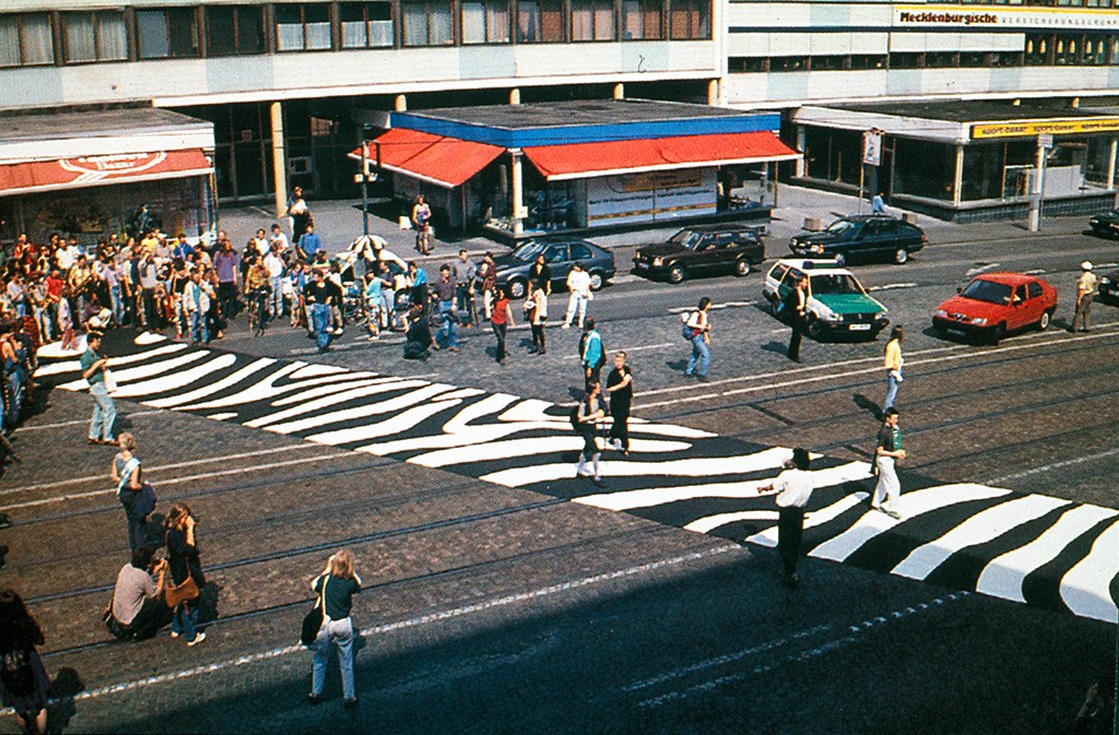 Vorrang für Fußgänger: Ein transportabler Zebrastreifen von Gerhard Lang und Lucius Burckhardt wurde 1993 in Kassel ausgerollt.